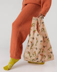 model carrying pink standard baggu with merbunny print
