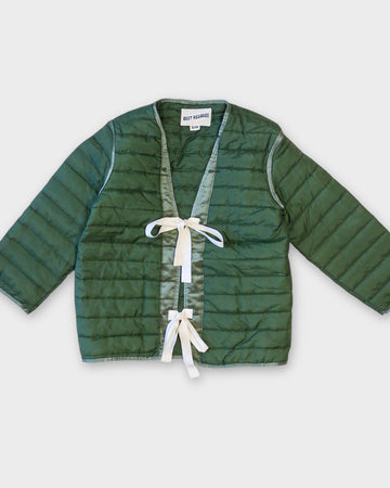 green quilted jacket with white double bow closure