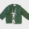 green quilted jacket with white double bow closure