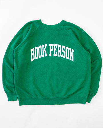 kelly green sweatshirt with white 'BOOK PERSON' across the front