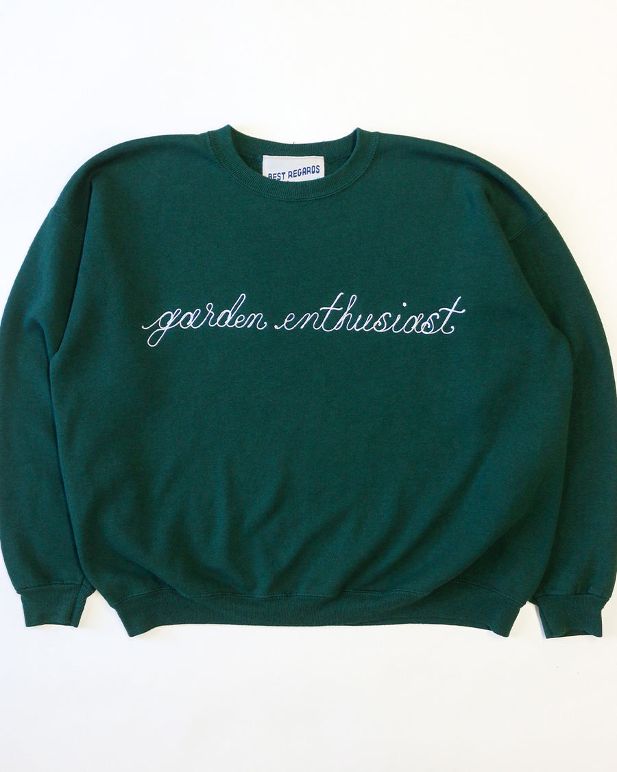 dark green sweatshirt with white chainstitch garden enthusiast across the front