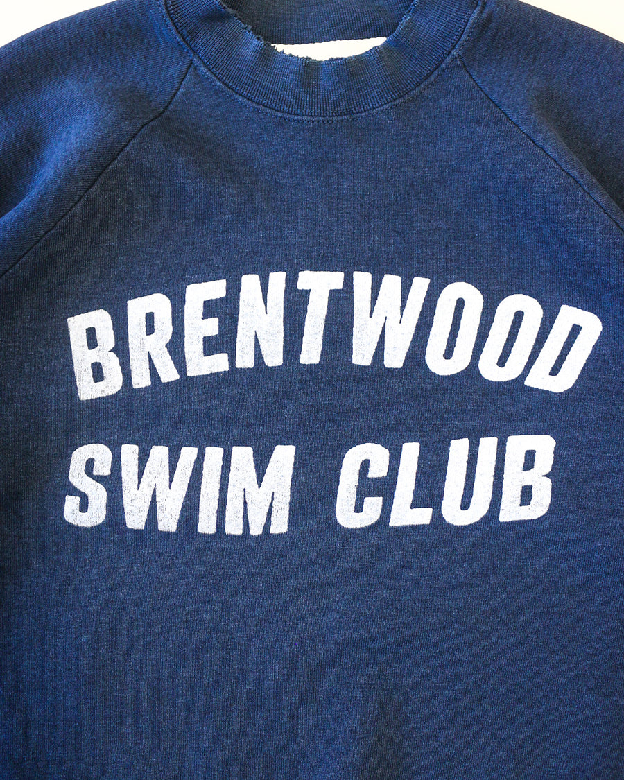 up close of navy sweatshirt with white 'BRENTWOOD SWIM CLUB' across the front