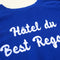 up close of royal blue sweatshirt with white 'Hotel du Best Regards' across the front