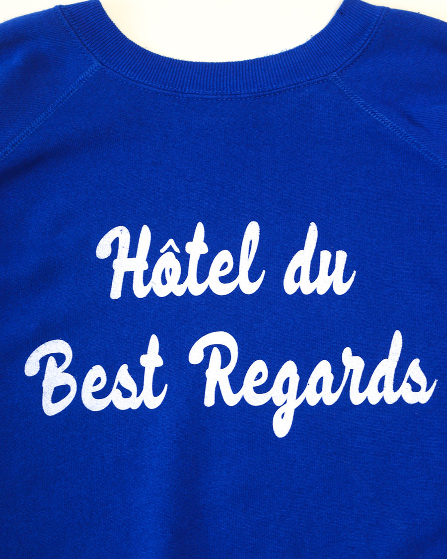 front view of royal blue sweatshirt with white 'Hotel du Best Regards' across the front