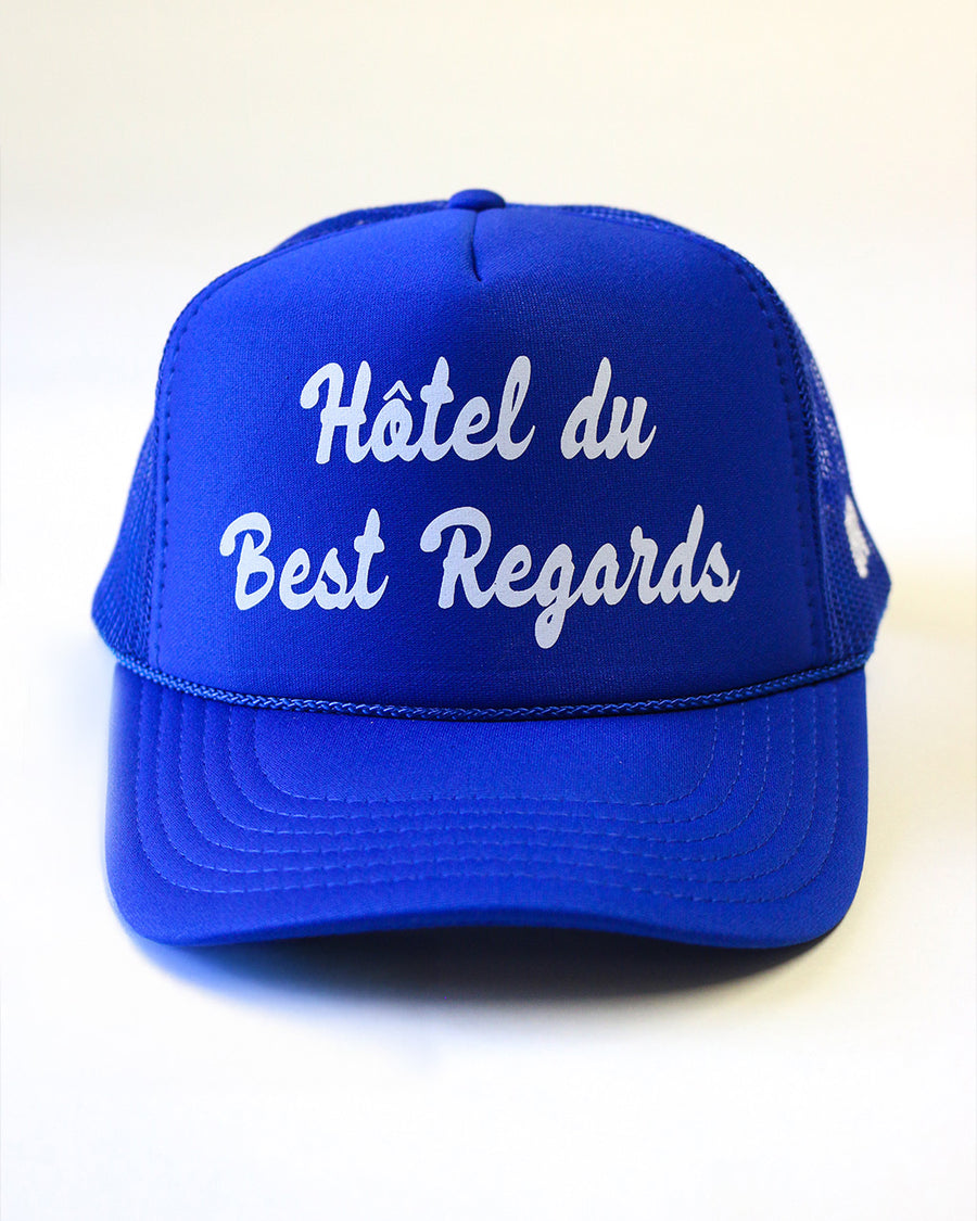 royal blue trucker hat with white 'HOTEL du BEST REGARDS' across the front