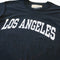 up close of black upcycled tee with white LOS ANGELES across the front