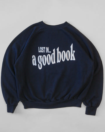 navy sweatshirt with white 'LOST IN... GOOD BOOK' across the front