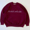 maroon sweatshirt with white chainstitch trinket collector across the front
