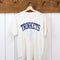 vintage white tee with navy TRINKETS across the front on a hanger