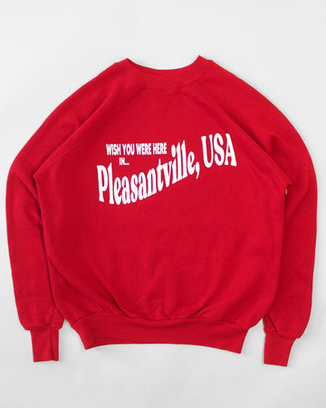 red sweatshirt with white 'WISH YOU WERE HERE IN...PLEASANTVILLE, USA' across the front