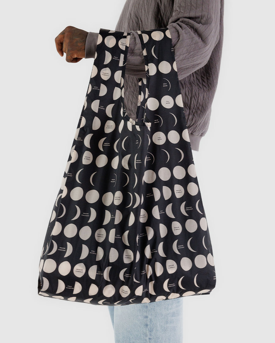 model holding black big baggu with white moon phases