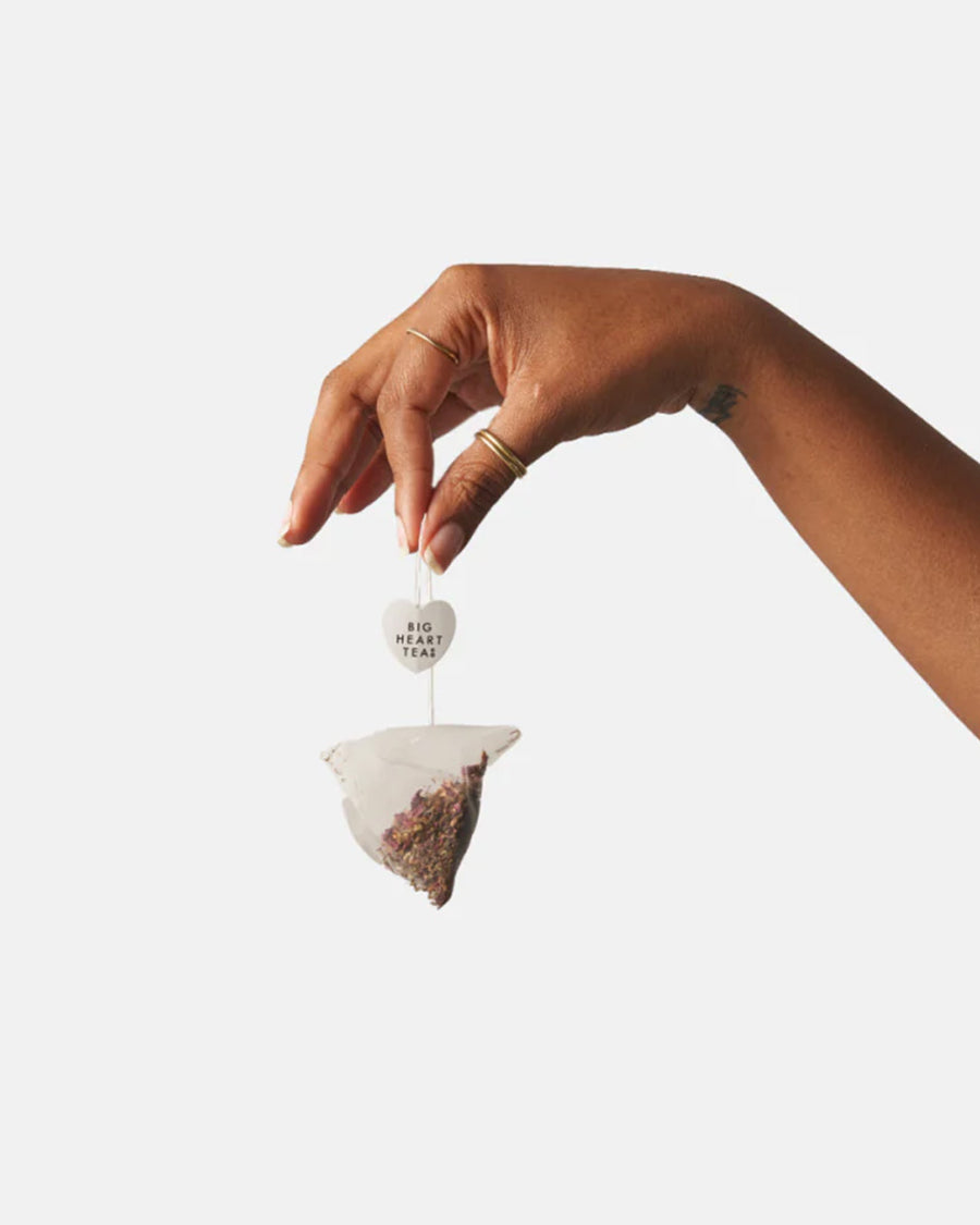 model holding chai tea bag