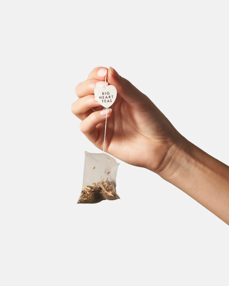 model holding chamomile mint  tea bag