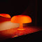 lit orange retro inspired mushroom lamp in dark room