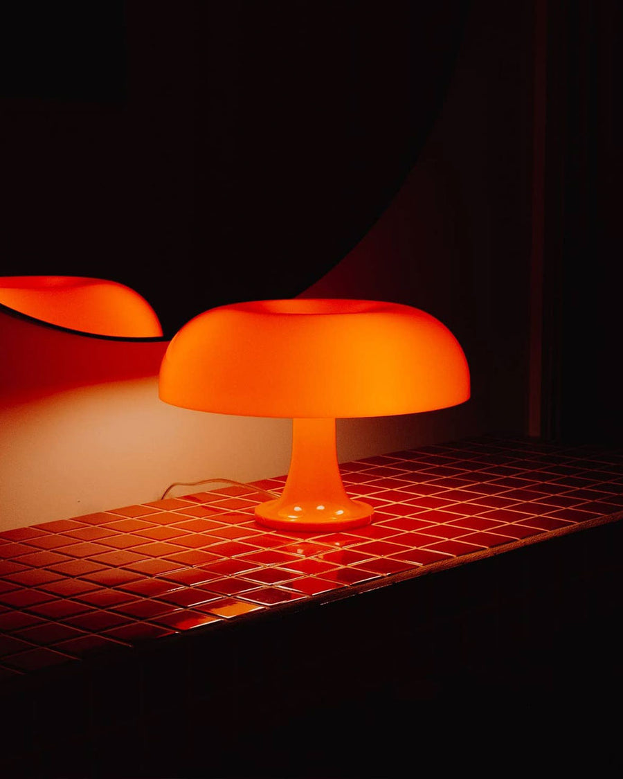 lit orange retro inspired mushroom lamp in dark room