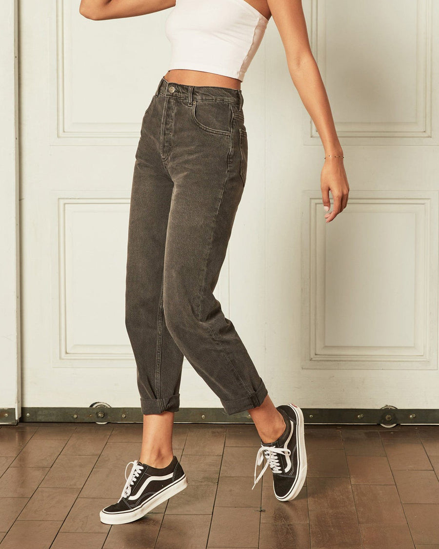 model wearing black high waist jeans with cuffed bottoms