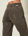 up close of back of model wearing black high waist jeans with cuffed bottoms