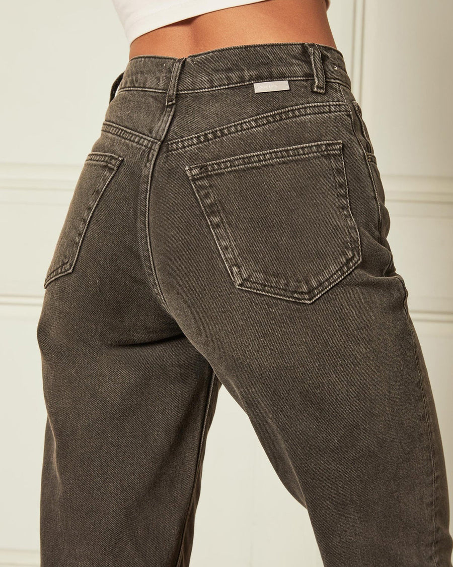 up close of back of model wearing black high waist jeans with cuffed bottoms