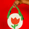 cream round purse with red tulip and green beaded leaves on the strap