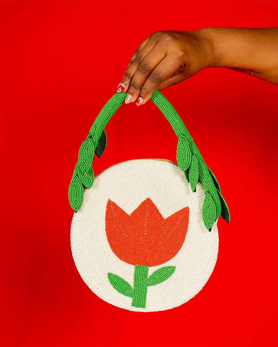 cream round purse with red tulip and green beaded leaves on the strap