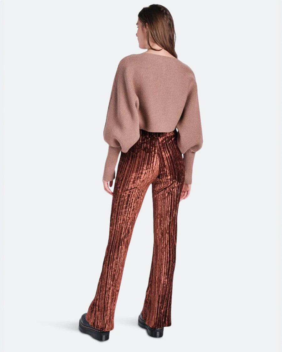 backview of model wearing brown crushed velvet flared pants