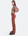 sideview of model wearing brown crushed velvet flared pants