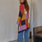 back view of model wearing multicolor checkered open front midi cardigan