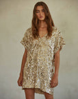model wearing gold sequin midi dress with short sleeves