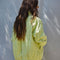 back view of model wearing lime quilted jacket