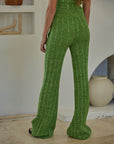 back view of model wearing green crochet knit flared pants