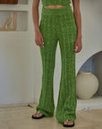 model wearing green crochet knit flared pants