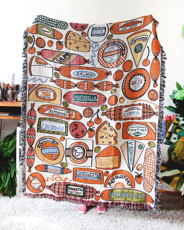 white tapestry blankets with all over meat and cheese print and fringe edges