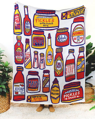 throw blanket with bottles of different condiments