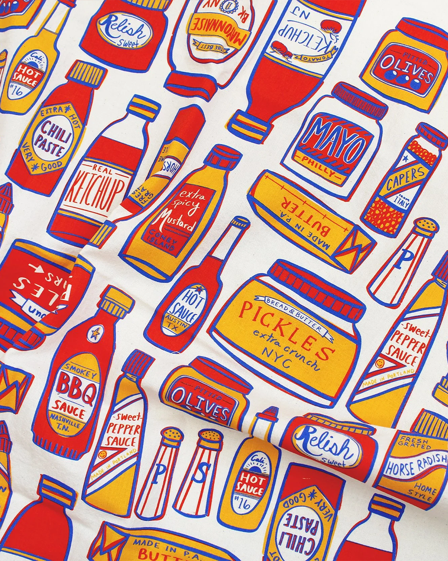 tea towel with different condiment bottles