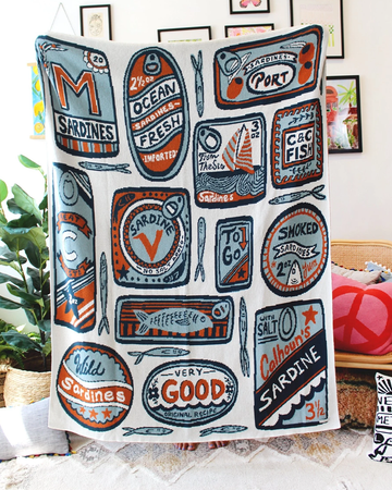 white tea towel with orange and blue sardine can print