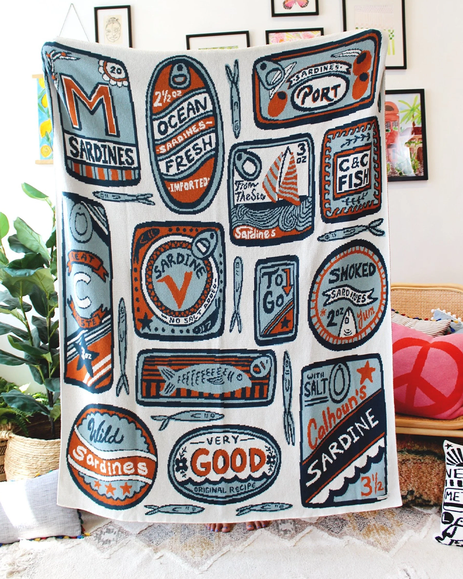 white tea towel with orange and blue sardine can print