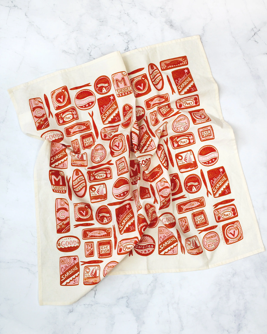 cream tea towel with pink and red sardine can print