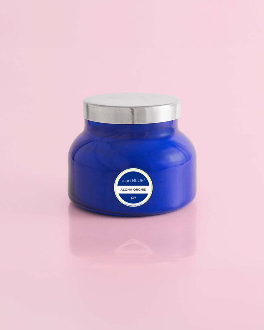 19 oz. aloha orchid candle in a sapphire blue jar