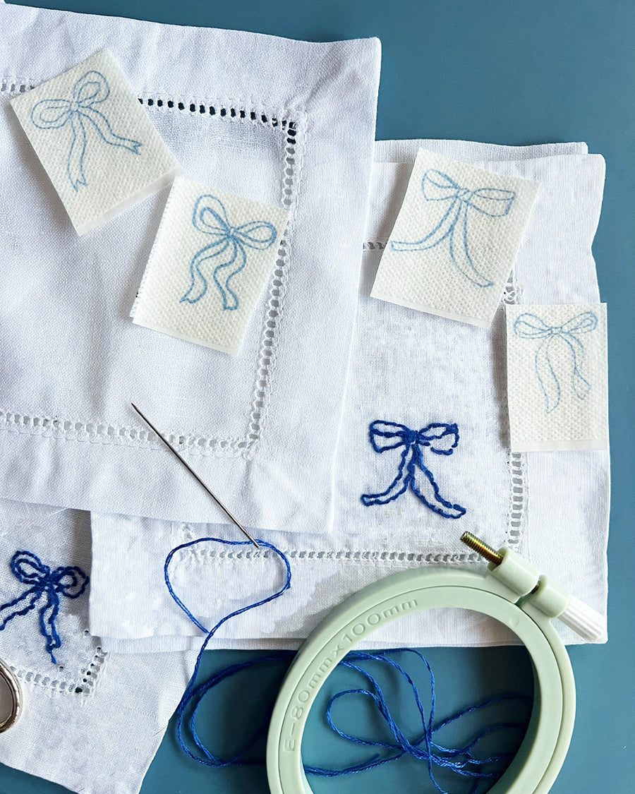 completed ribbon bow napkin embroidery set with embroidery ring, scissors, bow templates and dark blue embroidery tread
