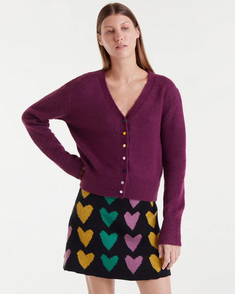 model wearing fuzzy burgundy cardigan with colorful button front