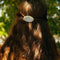 model wearing cornflower 'pyrex inspired' circle hair clip