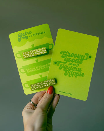 model holding set of two green 'pyrex inspired' hair clips