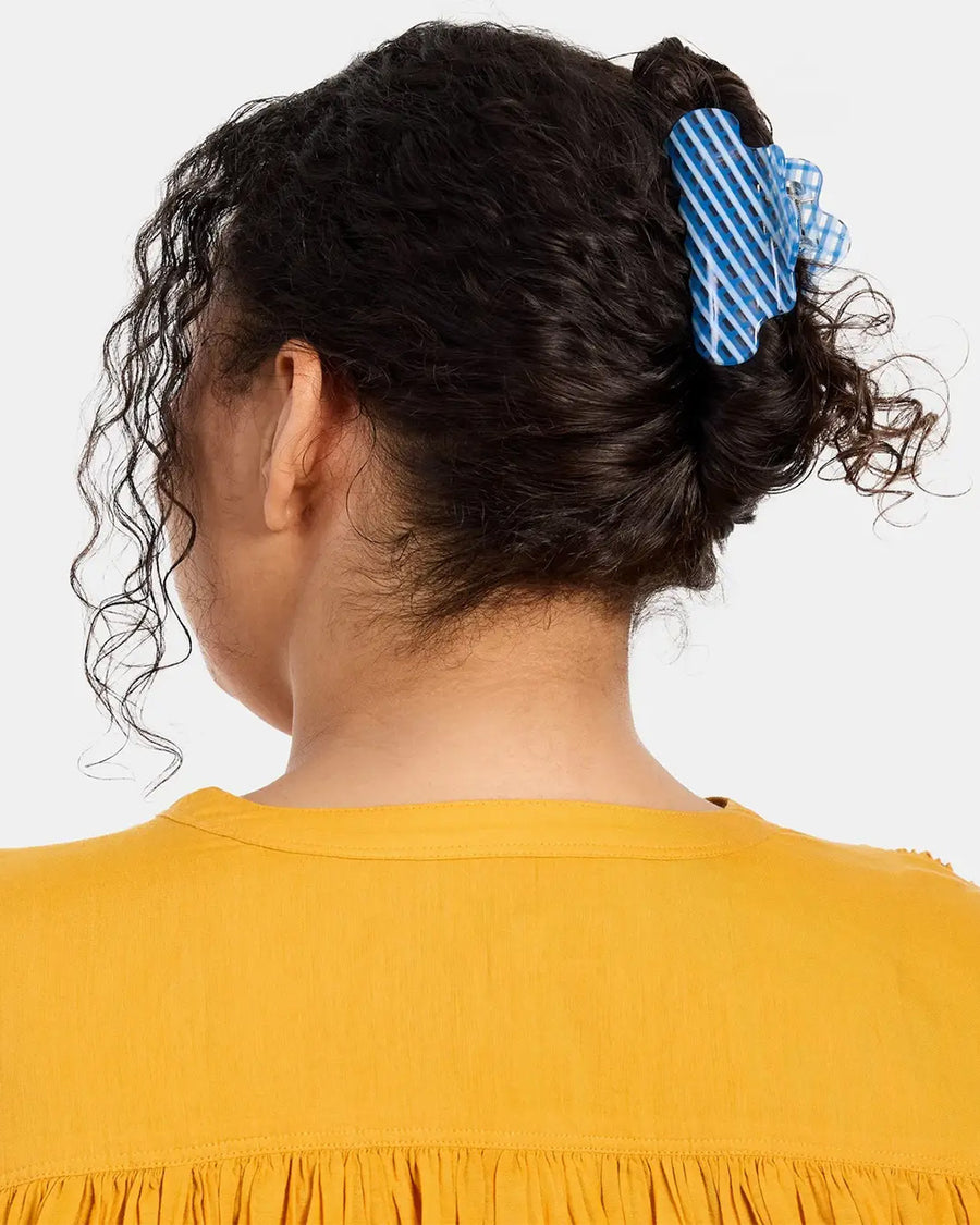 model wearing clear and blue plaid squiggle hair claw