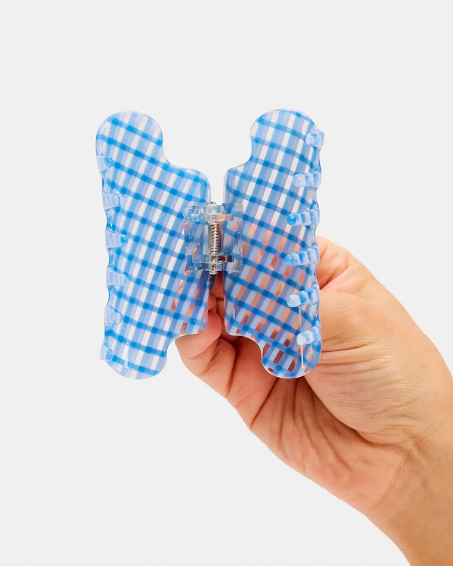 opened clear and blue plaid squiggle hair claw