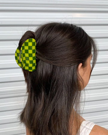 model wearing two toned green checkered hair claw
