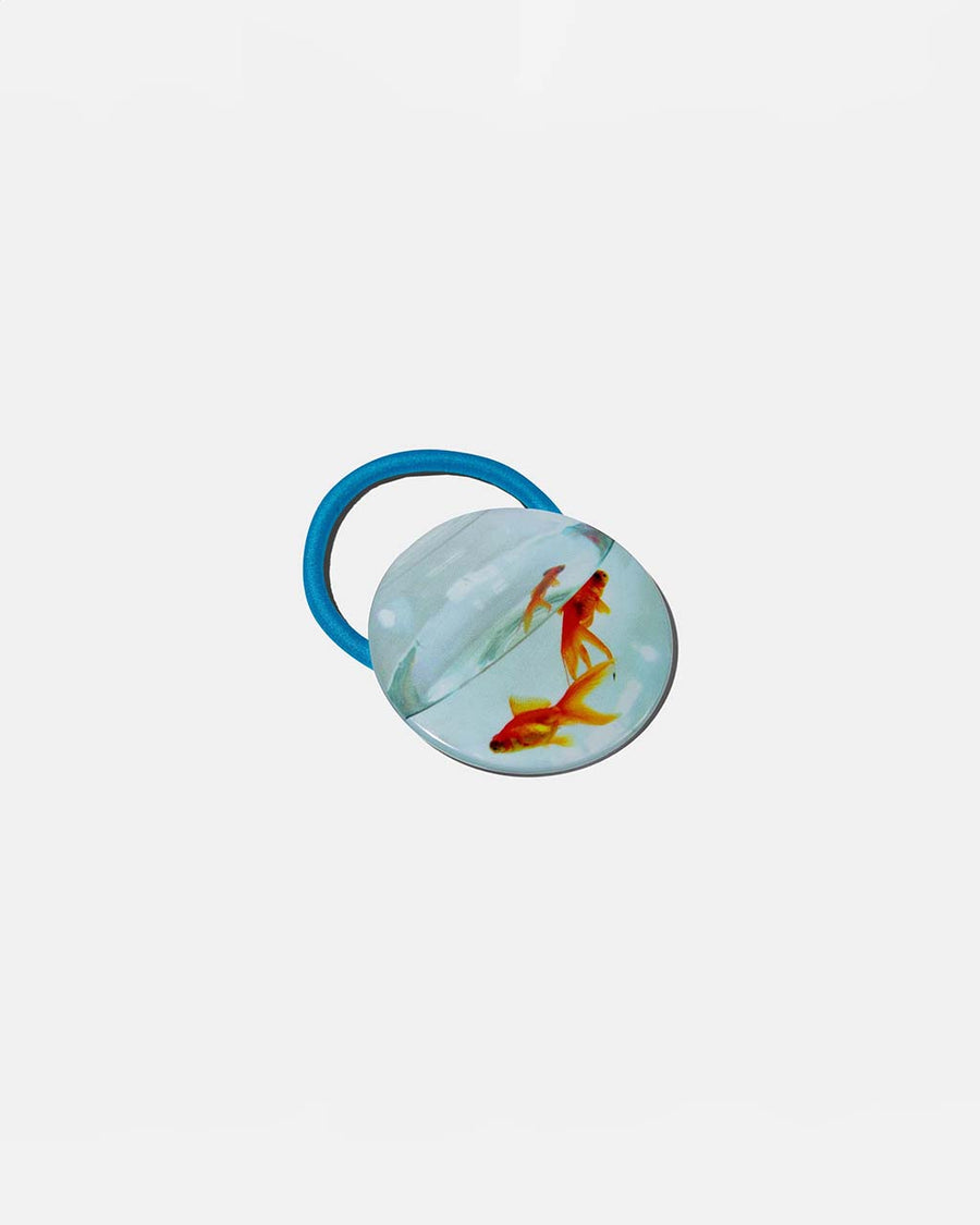 blue ponytail elastic with realistic circular fish bowl print medallion.