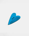 closed black heart compact with blue fine tooth comb