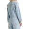 back view of model wearing light denim jumpsuit with button front, patch pockets, collar and long sleeves
