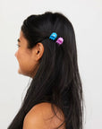 model with blue and purple micro clips in their hair