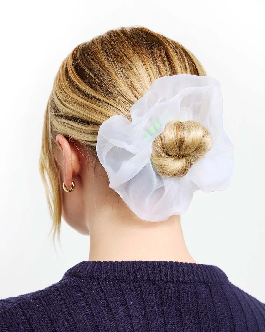 model wearing scrunchie with green coil band and white organza